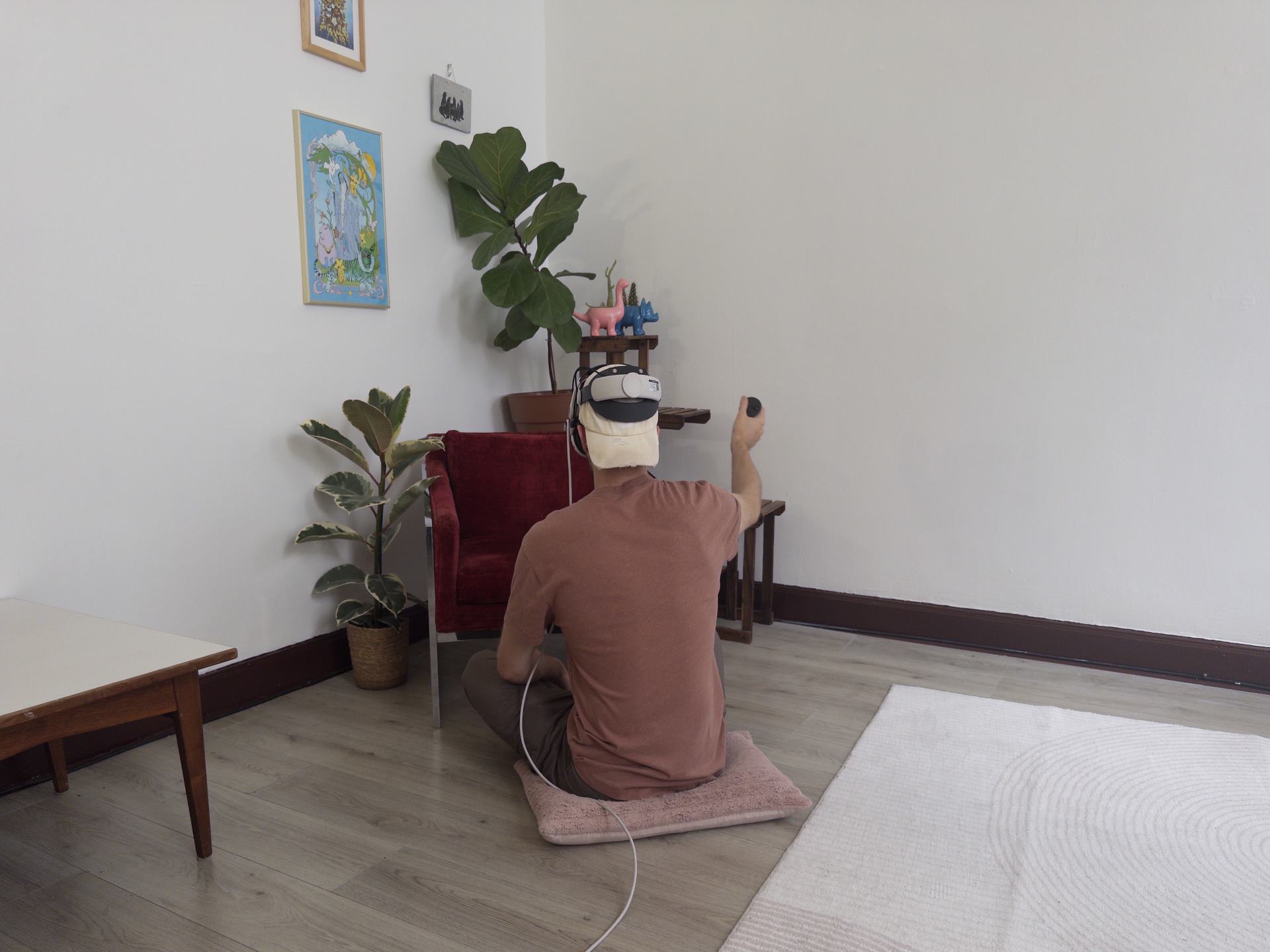 A man in a jumpsuit sitting over a table with some plants.